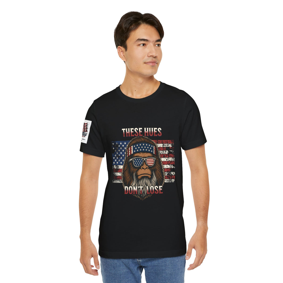 These Hues Don't Lose — Bigfoot American Flag Tee
